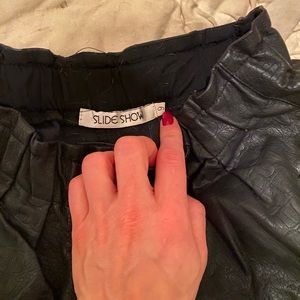Slide show faux leather black shorts size s